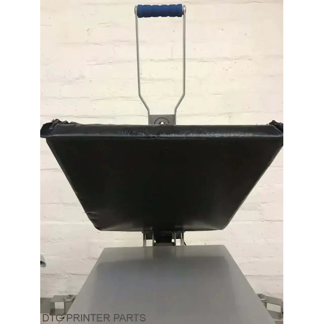 Rapid Slip Heat Press Upper Platen Cover 16X20: black trapezoidal platen, blue cushioned handle, steel frame over worktable.