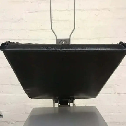 Rapid Slip Heat Press Upper Platen Cover 16X20: black trapezoidal platen, blue cushioned handle, steel frame over worktable.